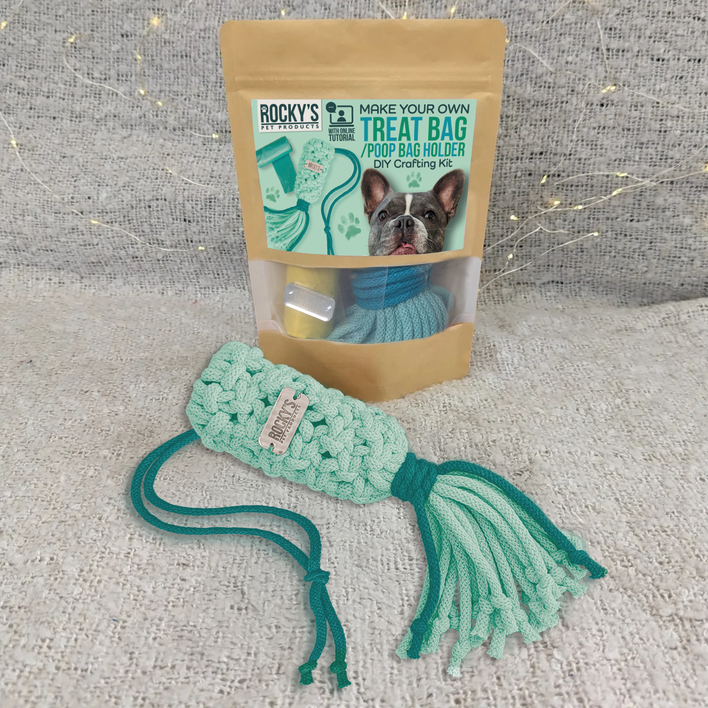 Teal dog treat bag holder with a Rocky's pet products packaging on a textured surface
